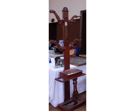 A Victorian mahogany hall stand, with mirror back with coathangers, glove box, with stick and umbrella stand and drip tray on