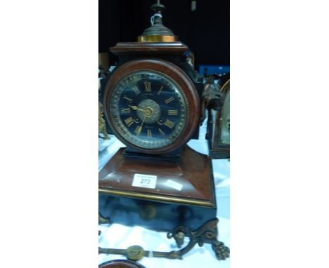 A Victorian red and black marble mantel clock, with ring handles and paw feet, the black dial with gold Roman numerals signed
