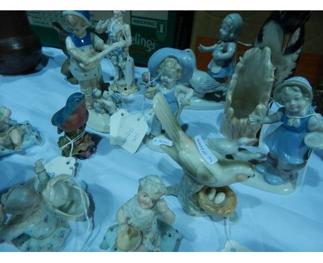 A quantity continental children figure groups, a Goebel model woodpecker, other bird and figure models 