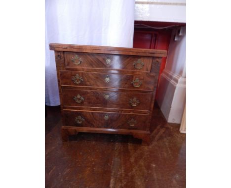 A Georgian style walnut foldover top chest of four long graduated drawers, raised on bracket feet, width 72cm