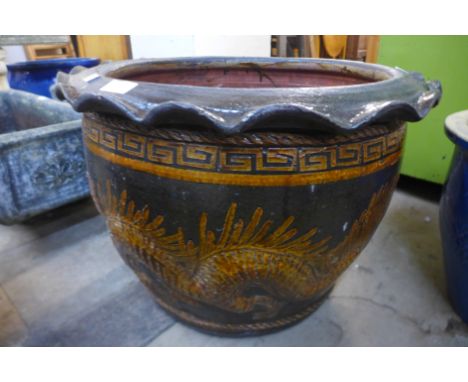 A large glazed oriental style terracotta garden planter 
