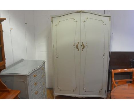 A vintage French style green painted and gilt armoire, with fitted interior. 208cm by 125cm by 63cm