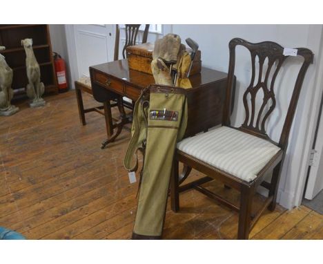 A 1920s/30s vintage golf bag in canvas with leather trim, complete with metal shafted clubs and original strap handle to side