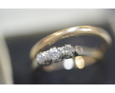 An 18ct yellow gold three stone illusion set diamond ring and a 9ct gold wedding band (2) 1.74 grams (first)