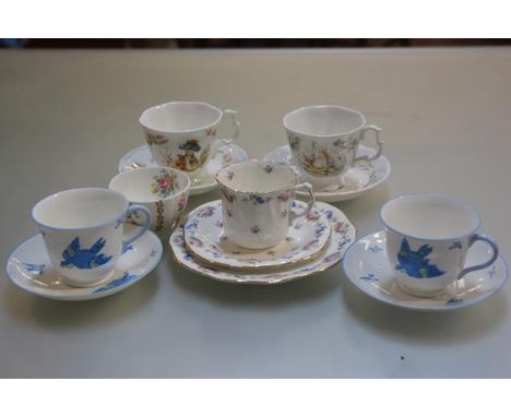 A pair of  Royal Albert World of Beatrix Potter cups and saucers, a pair of HM Williamsons Heathcote china bluebird decorated