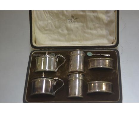 A Mappin &amp; Webb six piece table condiment set comprising two salt cellars, two pepperettes and two drum mustards, complet