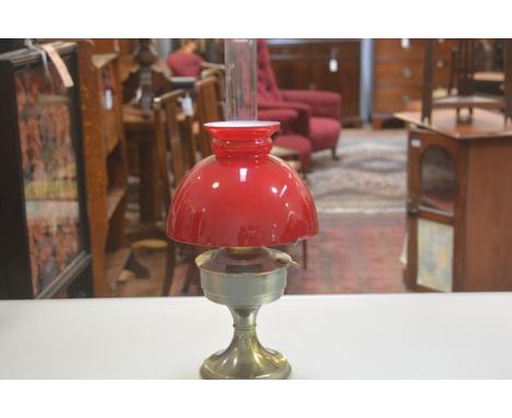A brass Victorian style oil lamp with red cased glass shade, complete with funnel, converted to electricity (h.44cm)