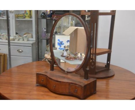 A George III mahogany swing mirror with oval plate, on scroll supports and serpentine inlaid base, on ogee bracket feet (one 