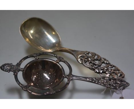 An Norwegian white metal Rococo style tea strainer, 830 standard and Elvesater 925 sterling silver spoon (2)