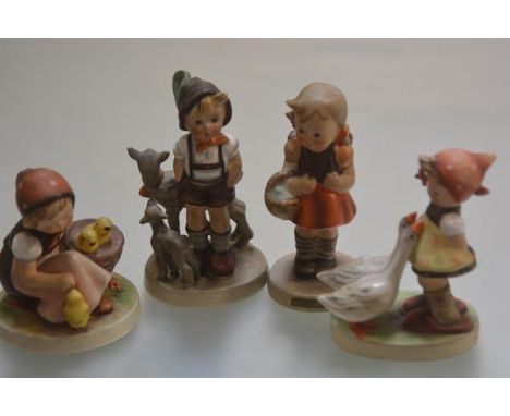 A collection of four Hummel figures including, Schoolgirl, Goosegirl and Little Goatherd, all decorated with polychrome ename