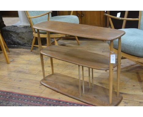 An Ercol light elm three tier stand with turned twin column supports (missing ball castors, top a/f)) (h.83cm x l. 90cm x w.3