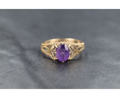 A 9ct gold amethyst ring, the oval cut amethyst measuring approximately 0.80ct, having pierced Celtic inspired shoulders, rin