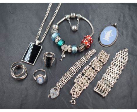 An assortment of silver and white metal jewellery, including a Pandora bracelet with Pandora and silver charms, Wedgwood pend