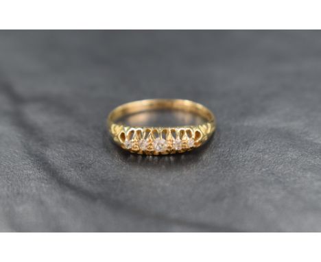 An 18ct gold five stone diamond ring, the graduated diamonds in an open gallery setting, ring size P, 2.3g