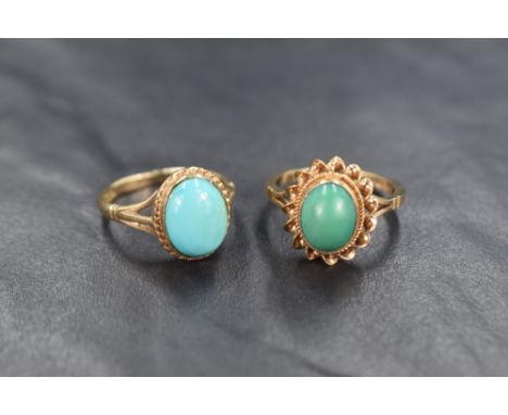 Two 9ct gold rings both having oval turquoise style cabochon stones, both in collared mounts with twist wire decoration on 9c