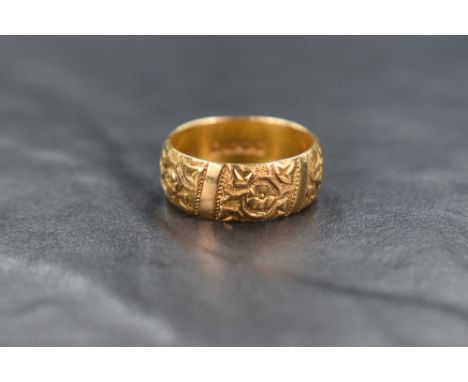 An 18ct gold band, having decorative floral motif panels, ring size O, 7.6g
Condition report: Overall good condition with cle