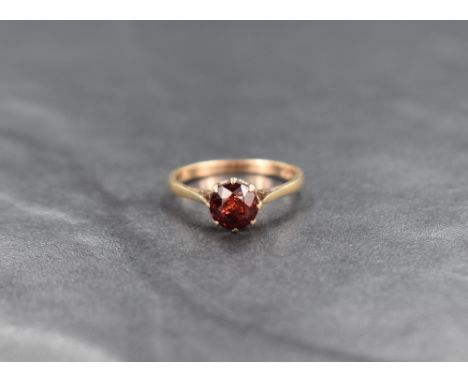 A 9ct gold garnet solitaire ring, the round cut garnet in an eight claw setting, ring size N, 1.8g