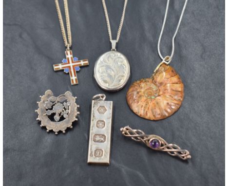 A small selection of silver and white metal jewellery including an oval locket, fossil pendant, ingot pendant and two brooche