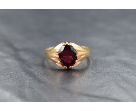 A 9ct gold garnet signet style ring, the central oval cut garnet measuring approximately 2ct, ring size S, 3.3g
