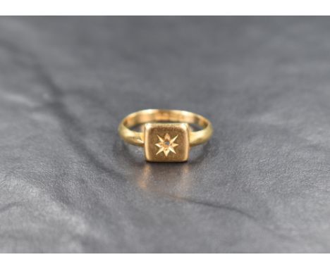 An 18ct gold signet style ring, the square panel missing the central gemstone within a star setting, ring size N, 3.3g