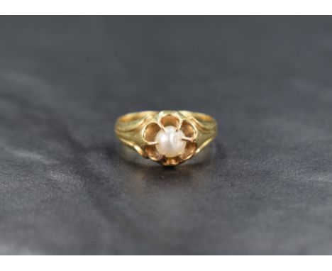 A baroque pearl set yellow metal gypsy ring having moulded detail to shoulders, no marks but presumed gold, size O &amp; appr