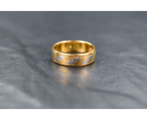 A 22ct gold and platinum band, the 22ct gold band having alternating decorative platinum panels with faint engraving, ring si