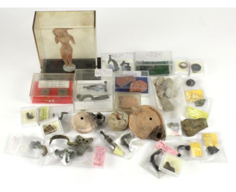 Artefacts (42) a collection of Roman, Romano-British and Celtic pieces. Noted brooches with and without pins; a sling shot fr