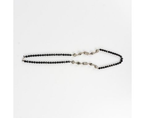 This necklace has black beads and silver metal links set with marcasite stones and rhinestones. Monet tag near the clasp. Dim