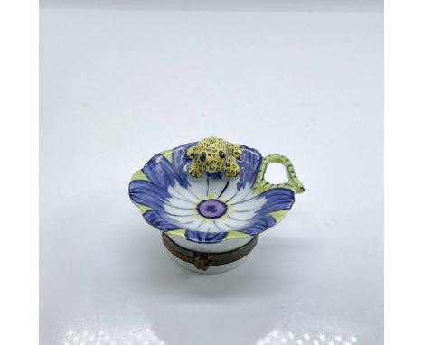 Hand painted porcelain treasure box with bronze tone hinged hardware modelled as a blue and white flower with a small yellow 