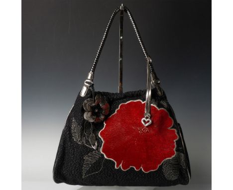 Black fabric with silver leather trim and shoulder straps decorated with large red flower. Interior zippered middle section a
