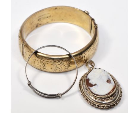 A silver engraved hinged bangle, Birmingham 1971, a sterling silver child's expanding bangle and a silver mounted shell cameo