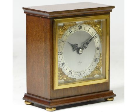 A mid 20th century Elliott 8 day mantel clock, mahogany case with silvered dial, brass bezel and Roman numerals, standing on 