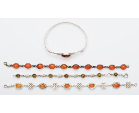 Three silver and amber bracelets and a similar bangle, 38gm 