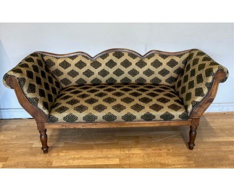 A Louis Philippe style sofa, the shaped mahogany back above outstretched scrolling arms and shaped rail on taperedturned legs