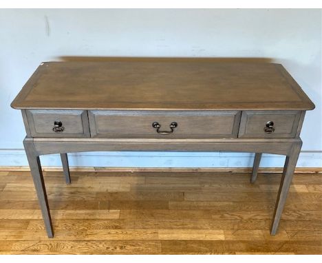 A modern Stag console/hall table, having central frieze drawer flanked by two short drawers with bronzed drop handles, raised