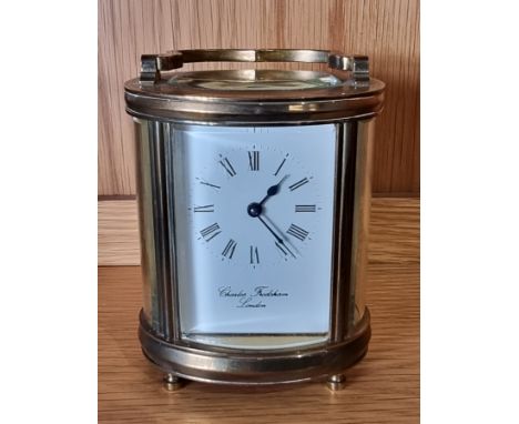 A mid 20th century English 8 day brass carriage clock, of oval form raised on bun feet, with key.12cm tall. 