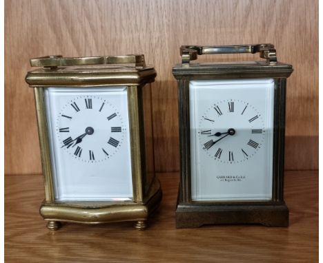 A Garrard &amp; Co Ltd brass 8 day carriage clock, 12cm tall, together with an unnamed example. (2) 