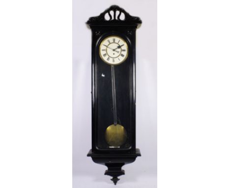 A late 19th century Vienna wall clock, having ebonised case with glazed door opening to a enamelled dial with Roman numerals,