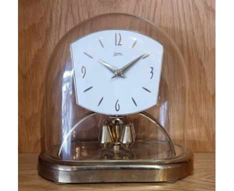 A mid 20th century Koma anniversary mantel clock, brass case with glass dome, the movement stamped Made in Germany.22cm tall.
