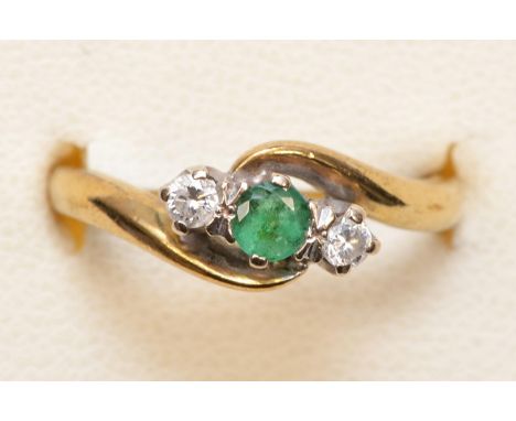 A 9ct gold emerald and brilliant cut diamond three stone ring, K, 2.5gm 