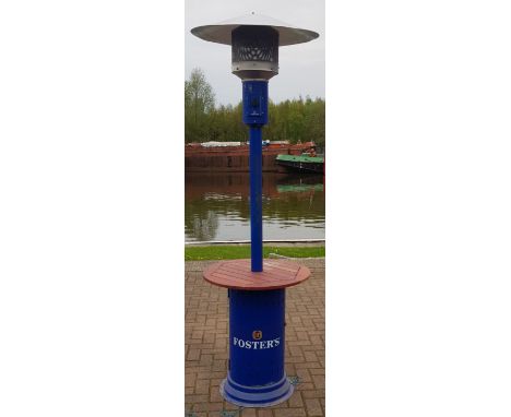 An advertising Fosters gas heater standing at approximately 7ft 3 with the burner stationed at the bottom with the two small 