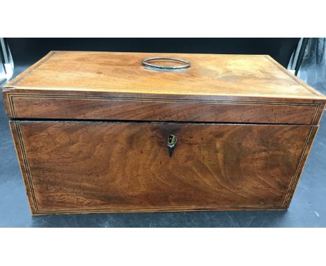 A Georgian mahogany tea caddy with string inlay and two lidded removable compartments inside. 