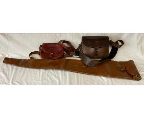 A collection of three leather bags used for hunting to include one large gun case 120cm l, and two other shoulder bags one ma