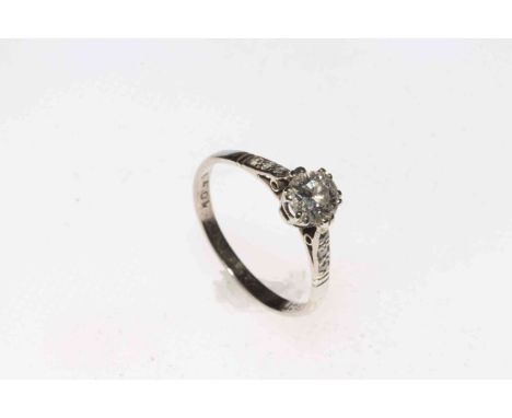 18 carat white gold solitaire diamond ring, the 0.7 approx carat diamond flanked by six brilliants, size N/O.