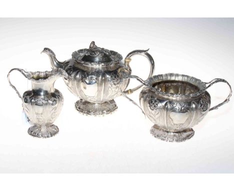 William IV silver three piece tea service, London 1837, having embossed and chased flower and fern leaf decoration.