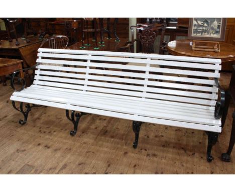 Wrought iron and wood slat scroll arm three seater garden bench, 81cm high by 214cm wide.