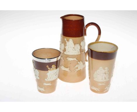 Doulton Lambeth brown stoneware jug and two beakers, one silver mounted (3).