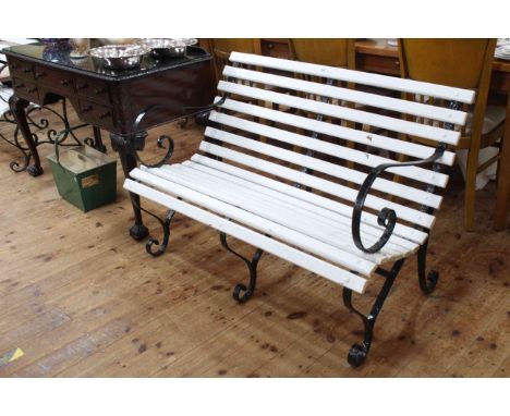Wrought iron and wood slat scroll arm two seater garden bench, 79cm high by 115cm wide.