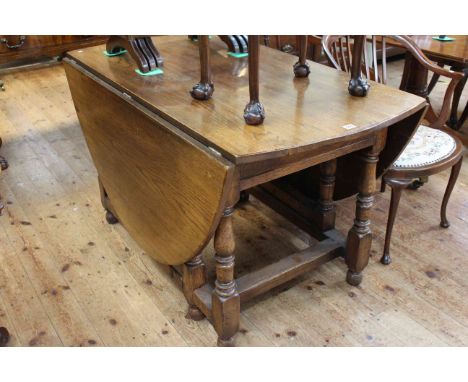 Large oak gate leg dining table having two frieze drawers and raised on turned legs, 75cm high by 73cm wide by 130cm long (le