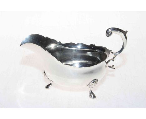 Barnard's silver sauce boat with scroll handle and hoof feet, London 1909.